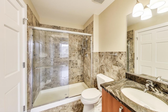4751 N Artesian Ave Unit 206, Chicago, IL 60625 - full bath featuring vanity, a stall shower, toilet, and tile walls