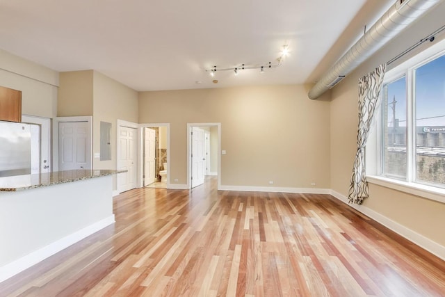 4751 N Artesian Ave Unit 206, Chicago, IL 60625 - unfurnished living room with light wood finished floors and baseboards