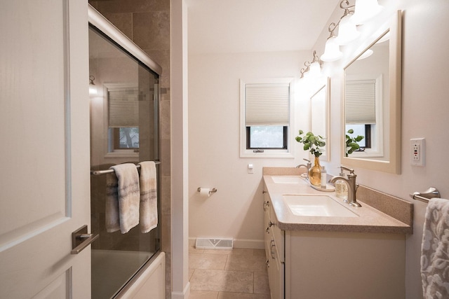 2148 Donahue St, Lasalle, IL 61301 - full bath with double vanity, tile patterned floors, enclosed tub / shower combo, and baseboards