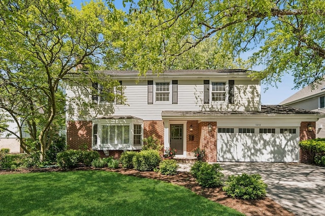 1312 Canterbury Ln, Glenview, IL 60025 - view of front of home with brick siding, driveway, a front yard, and an attached garage