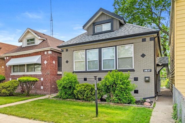 8837 S Morgan St, Chicago, IL 60620 - view of front of home featuring brick siding, a front yard, and roof with shingles