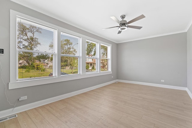 8837 S Morgan St, Chicago, IL 60620 - spare room with baseboards, light wood-style flooring, a ceiling fan, and crown molding