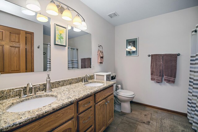 2609 E 1500s Rd, Kankakee, IL 60901 - full bathroom featuring double vanity, a shower with curtain, toilet, and baseboards