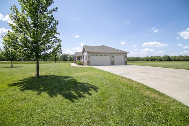 2609 E 1500s Rd, Kankakee, IL 60901 - view of front of house with a garage, a front yard, concrete driveway, and stone siding