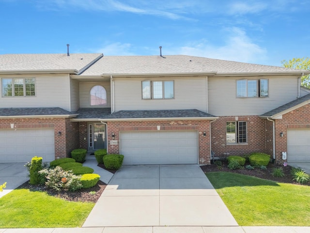 17964 Upland Dr, Tinley Park, IL 60487 - townhome / multi-family property featuring a garage, driveway, brick siding, and a front yard