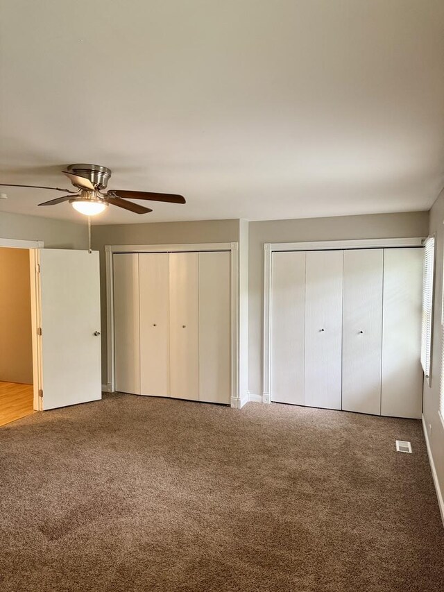 716 Shining Water Dr, Carol Stream, IL 60188 - unfurnished bedroom with two closets, carpet floors, and ceiling fan