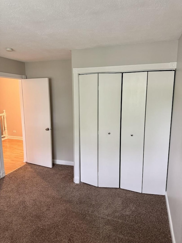 716 Shining Water Dr, Carol Stream, IL 60188 - unfurnished bedroom featuring carpet floors, a closet, and a textured ceiling