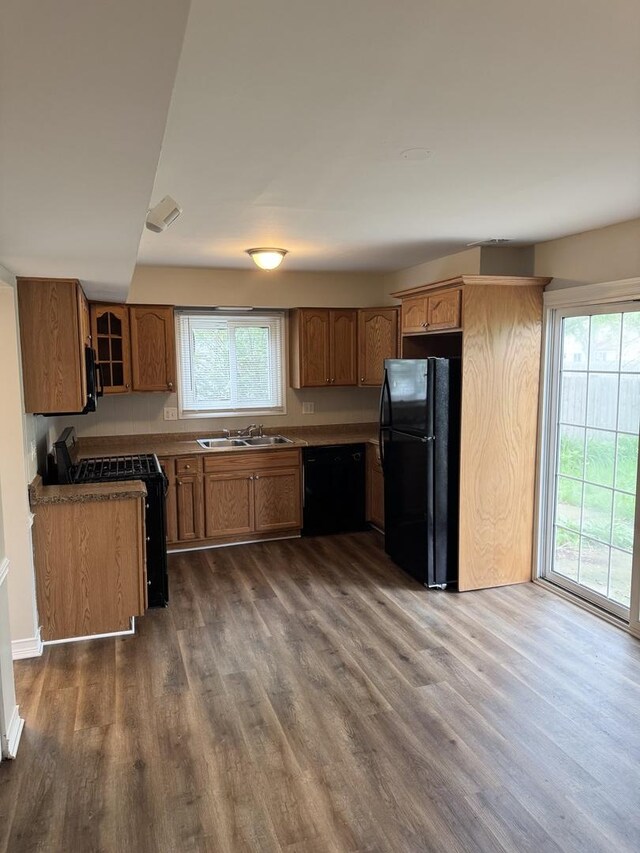 716 Shining Water Dr, Carol Stream, IL 60188 - kitchen featuring black appliances, brown cabinets, dark wood-type flooring, and healthy amount of natural light