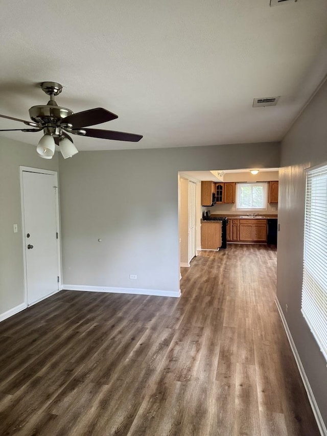 716 Shining Water Dr, Carol Stream, IL 60188 - unfurnished living room with dark wood-style flooring and a ceiling fan