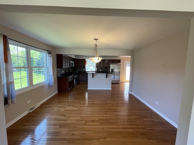 13153 W Pin Oak Dr, Homer Glen, IL 60491 - kitchen with appliances with stainless steel finishes, dark wood-type flooring, open floor plan, decorative backsplash, and baseboards