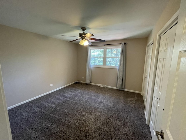 13153 W Pin Oak Dr, Homer Glen, IL 60491 - unfurnished bedroom with dark colored carpet, multiple closets, baseboards, and ceiling fan