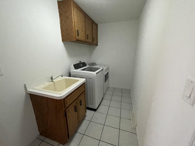 13153 W Pin Oak Dr, Homer Glen, IL 60491 - laundry area featuring washer and clothes dryer, cabinet space, light tile patterned floors, and baseboards