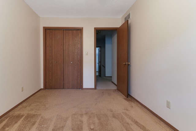 1560 Hunt Dr Unit A, Normal, IL 61761 - unfurnished bedroom with light colored carpet, a closet, and baseboards