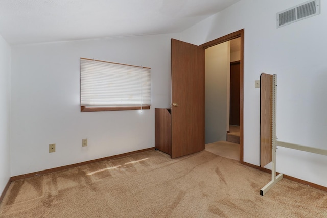 1560 Hunt Dr Unit A, Normal, IL 61761 - unfurnished bedroom featuring lofted ceiling, carpet flooring, and baseboards