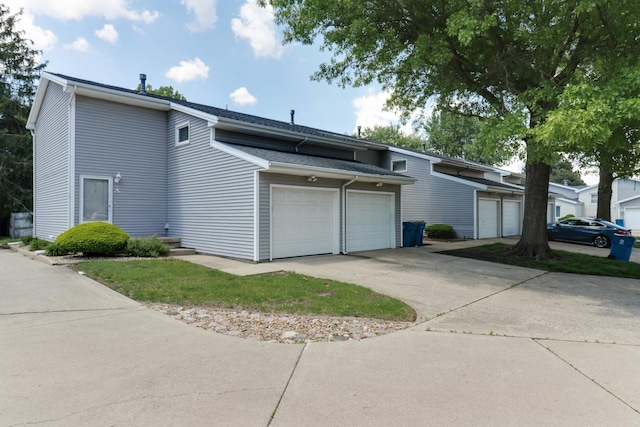1560 Hunt Dr Unit A, Normal, IL 61761 - view of side of property featuring an attached garage and concrete driveway