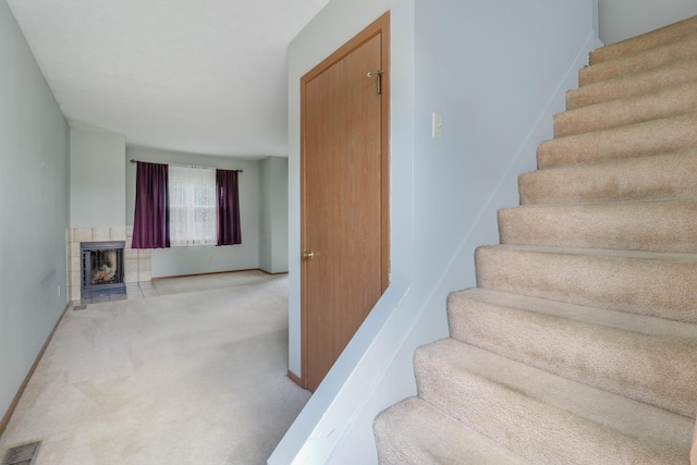 1560 Hunt Dr Unit A, Normal, IL 61761 - stairway featuring carpet flooring, a tile fireplace, and baseboards