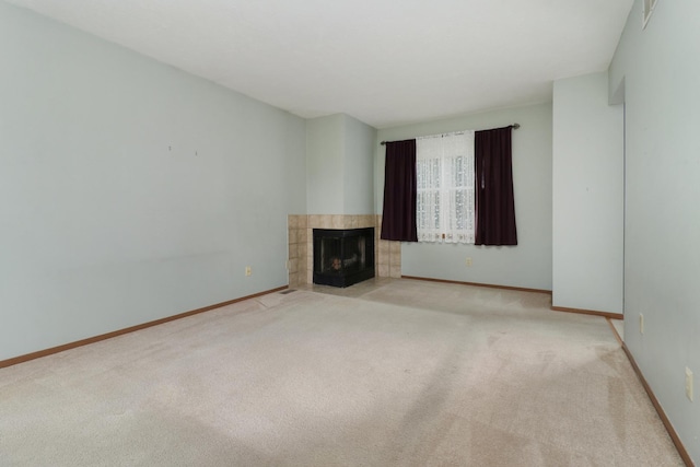 1560 Hunt Dr Unit A, Normal, IL 61761 - unfurnished living room featuring carpet flooring, a tile fireplace, and baseboards