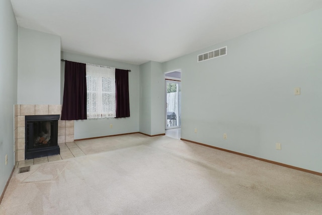 1560 Hunt Dr Unit A, Normal, IL 61761 - unfurnished living room with carpet, a tiled fireplace, and baseboards