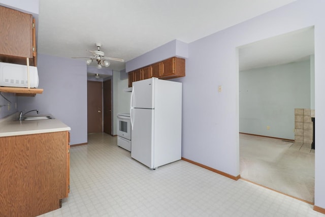 1560 Hunt Dr Unit A, Normal, IL 61761 - kitchen featuring white appliances, a ceiling fan, light countertops, baseboards, and brown cabinets