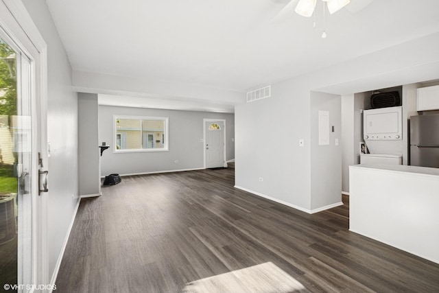 852 Oxford Pl Unit 852, Wheeling, IL 60090 - unfurnished living room featuring stacked washer / drying machine, dark wood-style floors, and baseboards