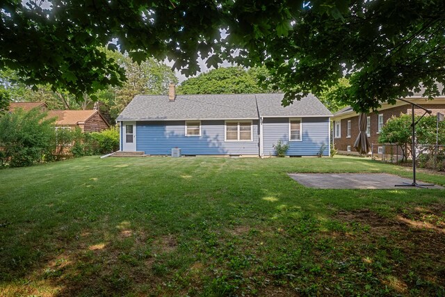 1223 S 3rd St, Saint Charles, IL 60174 - back of house featuring a yard, a chimney, and a patio area