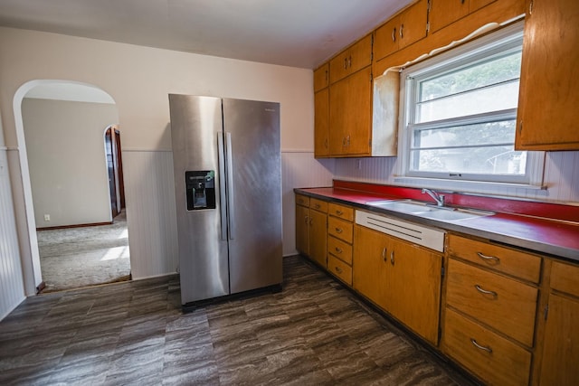 1223 S 3rd St, Saint Charles, IL 60174 - kitchen with stainless steel fridge, brown cabinets, a wainscoted wall, a sink, and arched walkways