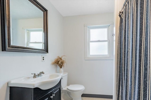 323 N 2nd Ave, Chenoa, IL 61726 - bathroom with vanity, toilet, healthy amount of natural light, and a shower with shower curtain