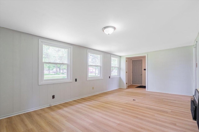 323 N 2nd Ave, Chenoa, IL 61726 - unfurnished living room with light wood-type flooring and baseboards