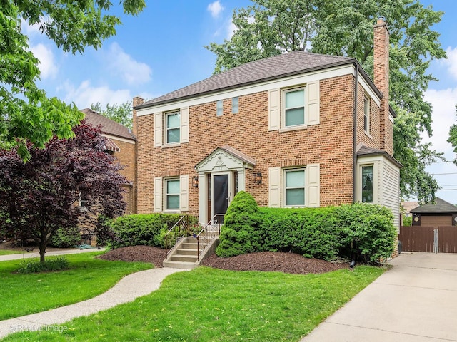 82 Northgate Rd, Riverside, IL 60546 - view of front of home with a chimney, brick siding, and roof with shingles