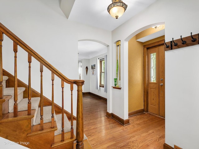 82 Northgate Rd, Riverside, IL 60546 - foyer entrance with arched walkways, light wood-type flooring, baseboards, and stairway