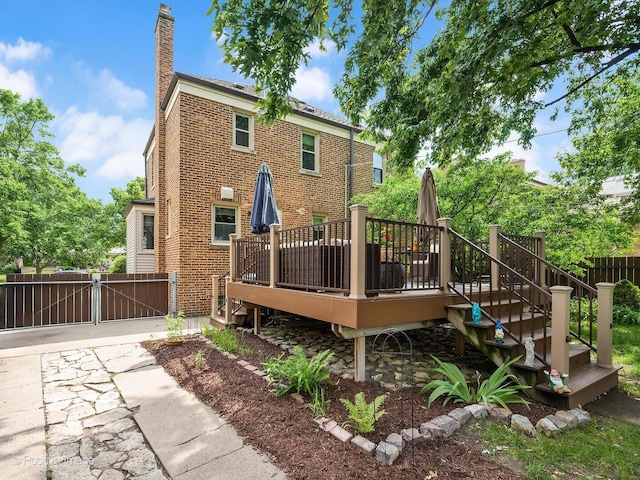 82 Northgate Rd, Riverside, IL 60546 - rear view of property with a chimney, a gate, a deck, and brick siding