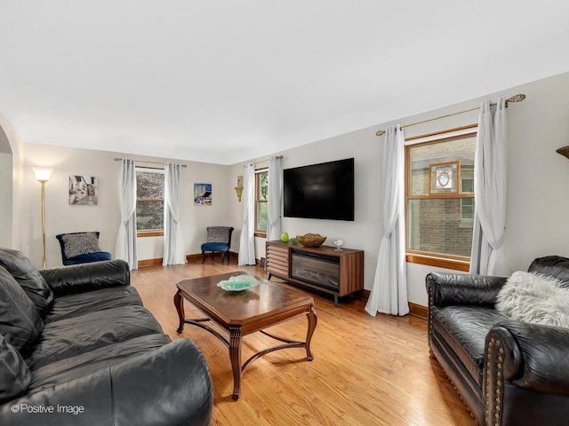 82 Northgate Rd, Riverside, IL 60546 - living room featuring light wood-style flooring, arched walkways, and baseboards