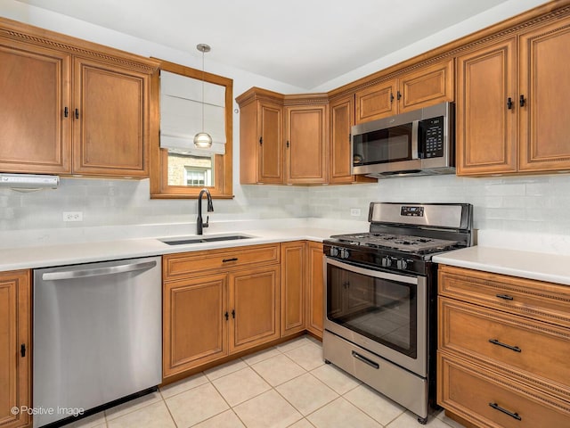 82 Northgate Rd, Riverside, IL 60546 - kitchen featuring stainless steel appliances, a sink, brown cabinetry, and tasteful backsplash