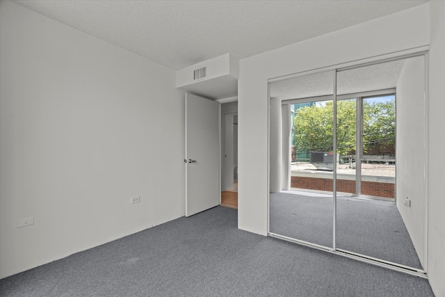 3120 S Indiana Ave Unit 207, Chicago, IL 60616 - unfurnished bedroom featuring carpet flooring, a textured ceiling, and a closet