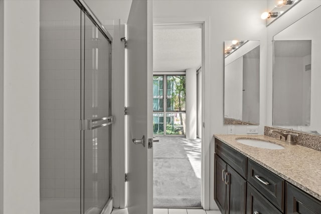3120 S Indiana Ave Unit 207, Chicago, IL 60616 - bathroom featuring a stall shower, vanity, and tile patterned floors