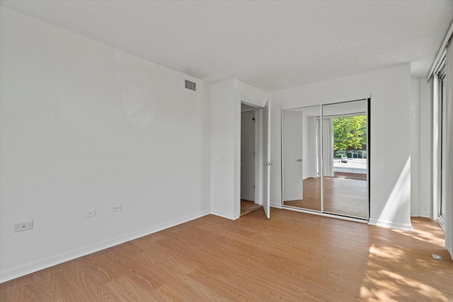 3120 S Indiana Ave Unit 207, Chicago, IL 60616 - unfurnished bedroom with light wood-type flooring, baseboards, and access to outside