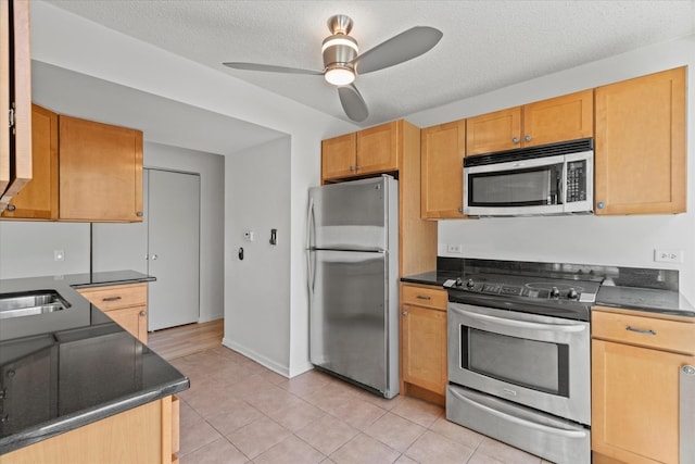 3120 S Indiana Ave Unit 207, Chicago, IL 60616 - kitchen with stainless steel appliances, dark countertops, ceiling fan, and a textured ceiling