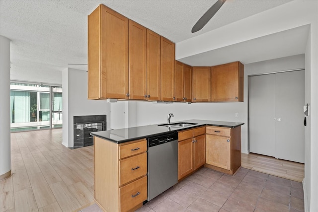 3120 S Indiana Ave Unit 207, Chicago, IL 60616 - kitchen with stainless steel dishwasher, a sink, dark countertops, a ceiling fan, and a textured ceiling