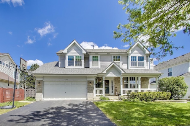1400 Patrick Dr, Mundelein, IL 60060 - traditional home featuring asphalt driveway, covered porch, brick siding, and a shingled roof