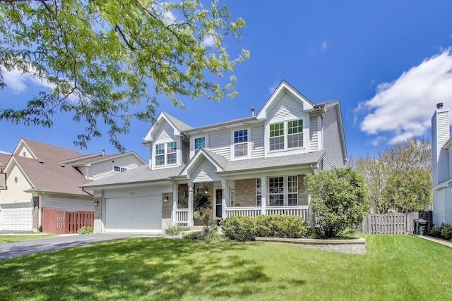 1400 Patrick Dr, Mundelein, IL 60060 - view of front of home featuring covered porch, asphalt driveway, an attached garage, and stone siding
