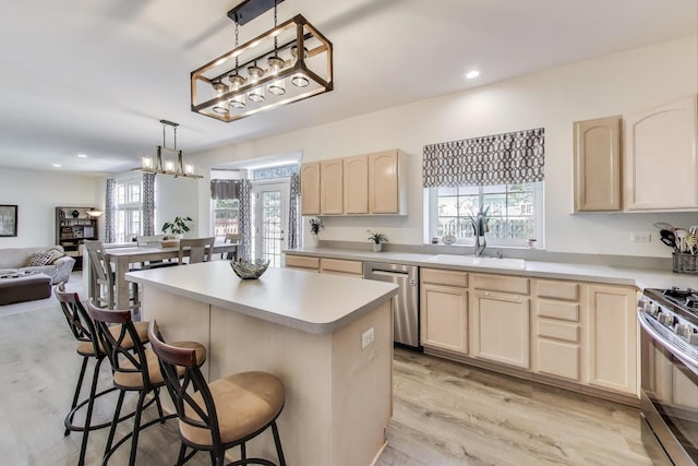 1400 Patrick Dr, Mundelein, IL 60060 - kitchen with stainless steel appliances, light brown cabinets, a kitchen bar, a sink, and recessed lighting