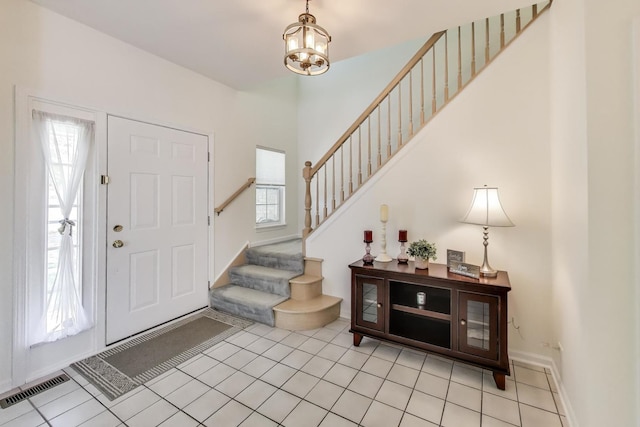 1400 Patrick Dr, Mundelein, IL 60060 - foyer entrance featuring stairs, a chandelier, light tile patterned floors, and baseboards