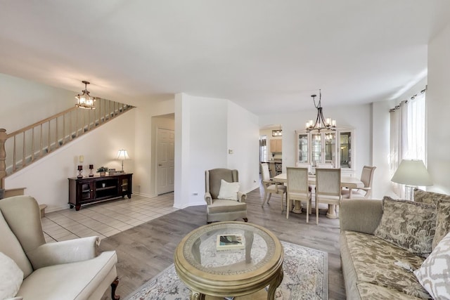 1400 Patrick Dr, Mundelein, IL 60060 - living area featuring a chandelier, stairway, light wood-style flooring, and baseboards