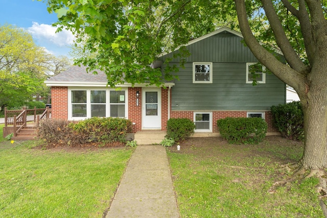 603 Geddes Ave, Winthrop Harbor, IL 60096 - tri-level home with a front yard, a deck, and brick siding