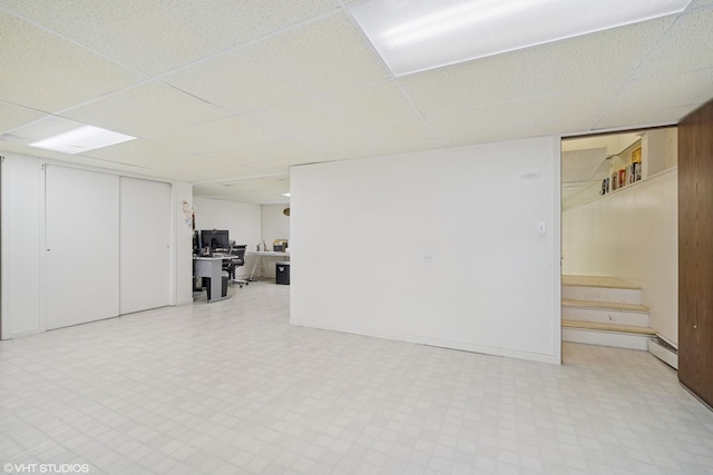 734 S Warren Ave, Palatine, IL 60074 - finished below grade area featuring tile patterned floors, a paneled ceiling, a desk, a baseboard heating unit, and stairs