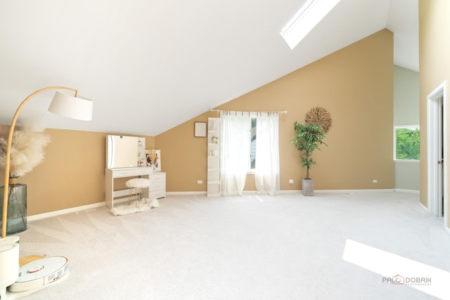 112 Ravine Ln, North Barrington, IL 60010 - unfurnished living room featuring a skylight, vaulted ceiling, carpet floors, and baseboards