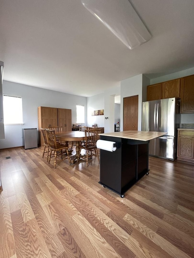 749 S Vintage Ln, Round Lake, IL 60073 - kitchen featuring freestanding refrigerator, light wood-style flooring, light countertops, and a center island
