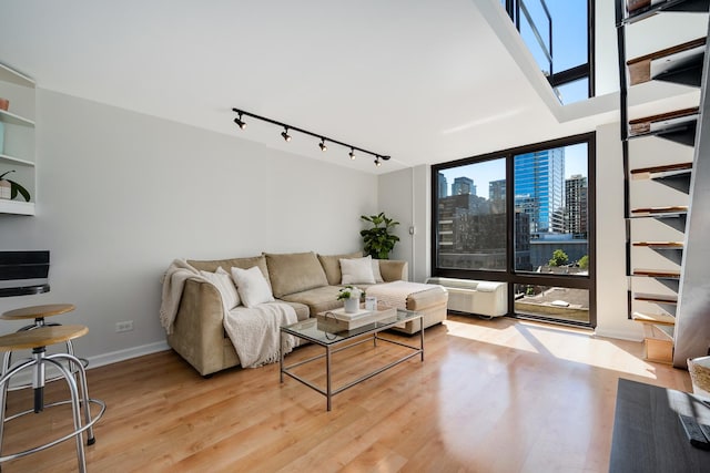 1221 N Dearborn St Unit 601S, Chicago, IL 60610 - living area with track lighting, healthy amount of natural light, a view of skyline, wood finished floors, and floor to ceiling windows