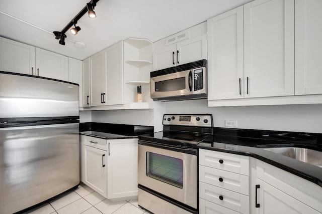 1221 N Dearborn St Unit 601S, Chicago, IL 60610 - kitchen with stainless steel appliances, open shelves, white cabinetry, light tile patterned flooring, and dark countertops