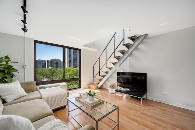 1221 N Dearborn St Unit 601S, Chicago, IL 60610 - living area with stairs, wood finished floors, track lighting, baseboards, and a wall of windows